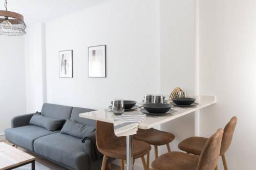 a living room with a couch and a table and chairs at Town Hall in Bilbao