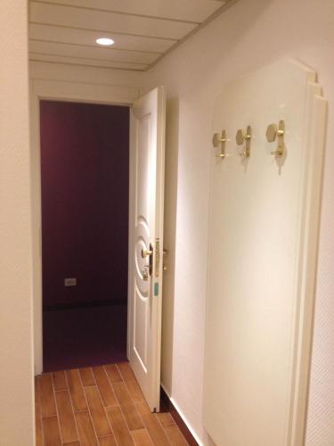 a hallway with a white door and a black room at Grande Albergo Potenza in Potenza