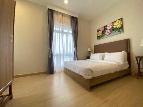 a bedroom with a bed and a large window at Timurbay by Seascape in Kuantan