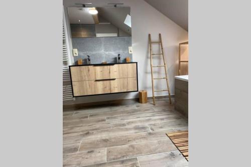 a room with a wooden cabinet and a ladder at Valgrange in Tenneville