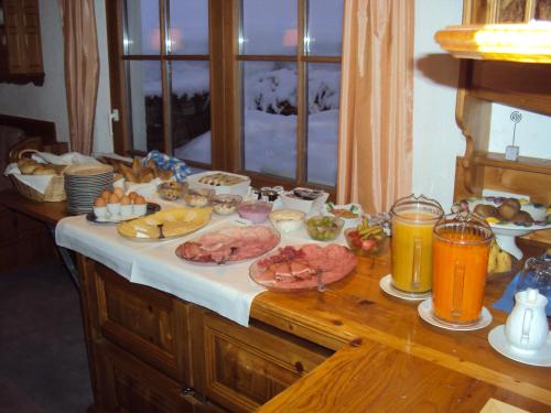 a table with food and drinks on top of it at Pension Sursilva in Gargellen