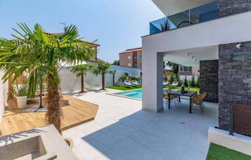 a patio with a dining area and a house at Superb Design Villa Medulin in Medulin