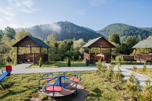 a park with two gazebos and a playground at Рибничанка in Skhidnitsa