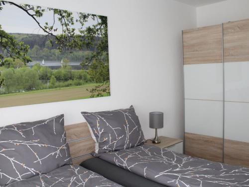 a bedroom with a bed and a picture on the wall at Ferienwohnungen am Seeufer in Möhnesee