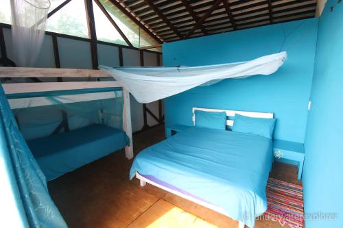 a blue room with a bunk bed and a canopy at Underwater Explorer in Ponta do Ouro