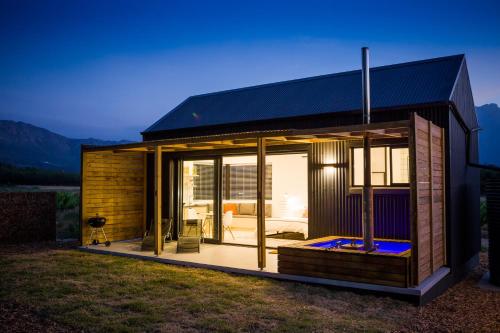 a small house with a black roof at Gite in Franschhoek