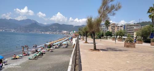a beach with a bunch of people sitting on beach chairs at civico sei rooms in Salerno