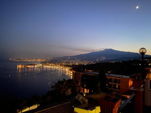 a view of a city and a body of water at Hotel Elios Tao in Taormina