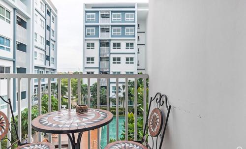 a balcony with a table and chairs on a balcony at The trust huahin sky room condo pool view in Hua Hin