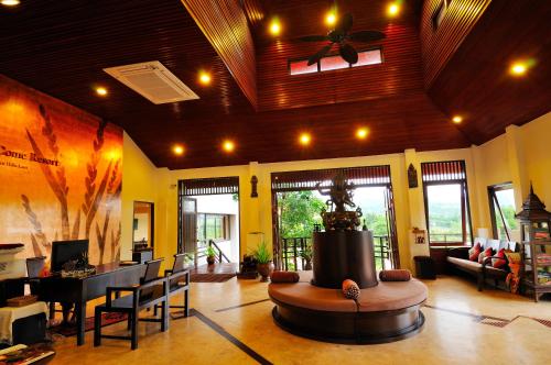 a large living room with a fountain in the middle at Phunacome Resort in Dan Sai