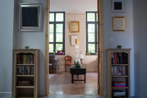 a hallway with two bookshelves and a living room at Hotel Galla Placidia in Narbonne