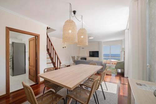a dining room with a table and chairs at Reis Magos V by An Island Apart in Caniço