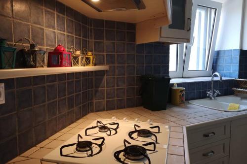 a kitchen with three burners on a counter top at Mina's Kypri Apartment in Kypri