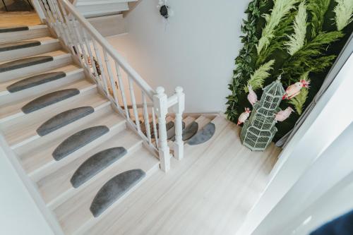a stairway with a potted plant next to it at Baltic Sea Dunes Apartments in Jūrmala