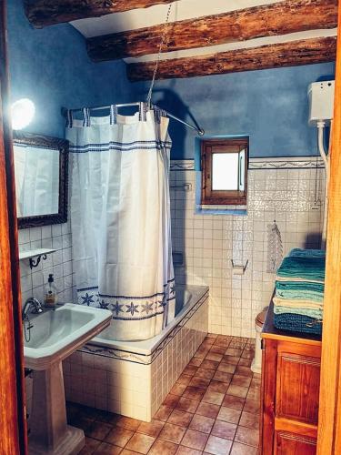 a bathroom with a shower curtain and a sink at Casa Alejandra in Fiscal
