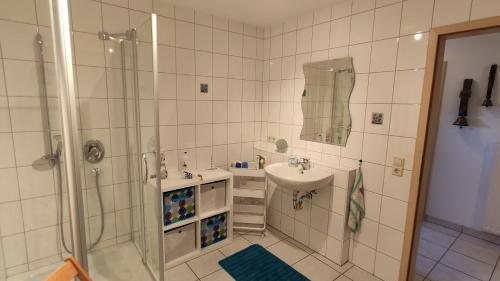 a bathroom with a shower and a sink at Ferienwohnung Albblick in Albstadt