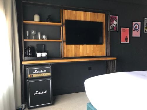 a entertainment center with a television in a room at The Baltic Hotel in Liverpool