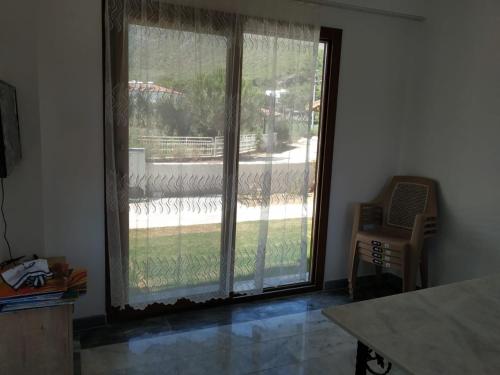 a large sliding glass door with a view of a yard at EVALiN in Mugla