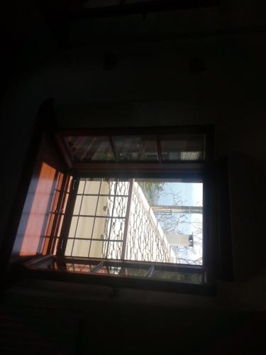 a window in a room with a staircase at Seirios in Vizitsa