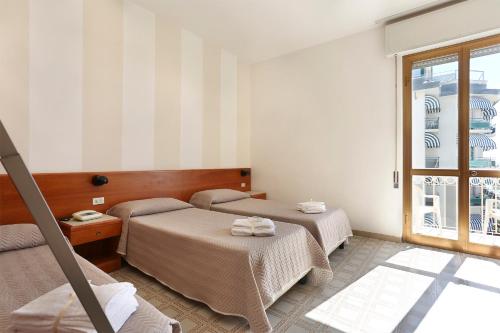 Cama o camas de una habitación en Hotel Brunella