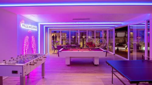 a room with ping pong tables and a room with a pool table at #1 Luxury Villa with Pool, Gameroom, Spa, Zen Yard in Belgrade