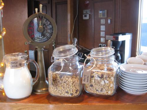 three jars of granola and milk on a table at Passengership Avanti in Amsterdam