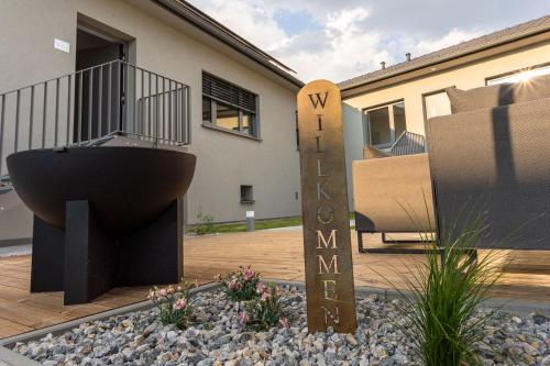 a house with a sign that says w stairway me at Apartments Galumbo - bleiben & genießen in Illmitz