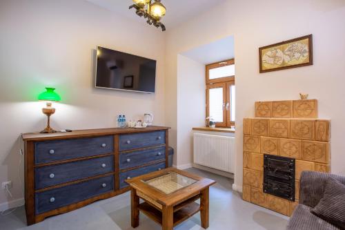 a living room with a dresser and a tv at Aparthotel Zakątna B&B in Tarnów