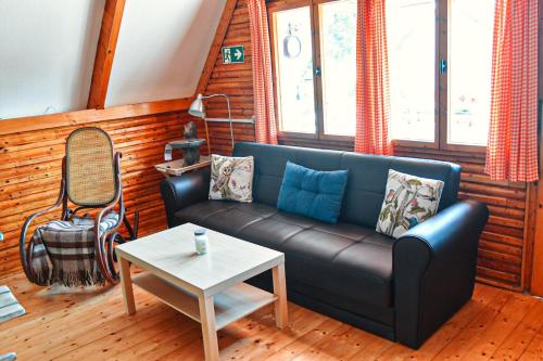 a living room with a couch and a table at Aqua Faház in Mesteri