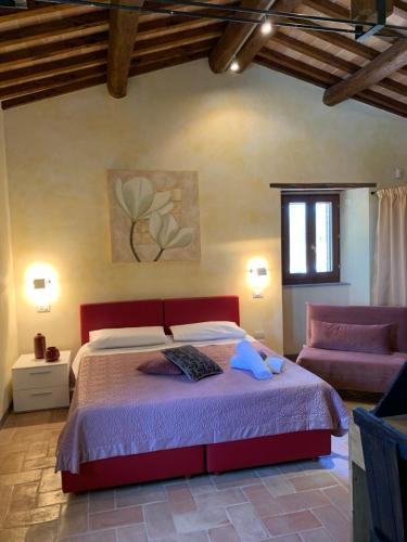 a bedroom with a red bed and a window at Domus Clara in Assisi