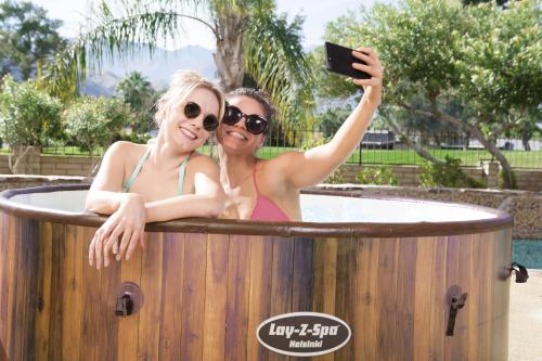 two women taking a picture in a hot tub at Bubble Tent Hotel in Weyregg