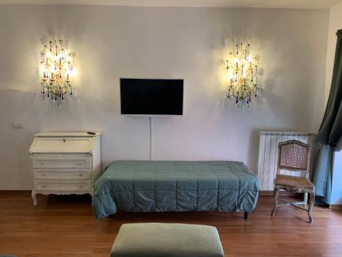 a bedroom with a bed and a tv on the wall at Le stanze di Anna Rita all'Arco Polinori in Foligno