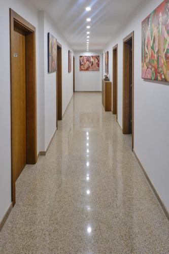 a corridor of an art gallery with paintings on the walls at Hotel Splendid in Pleven