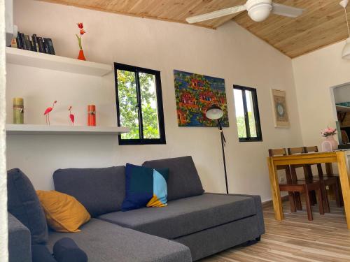 a living room with a couch and a table at Haus unter Palmen in Jarabacoa