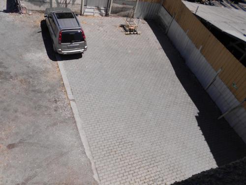 a car parked in a parking lot next to a building at Hotel Terramar in Talcahuano