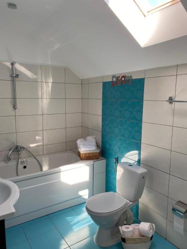 a bathroom with a toilet and a tub and a sink at Casa Andrei in 2 Mai