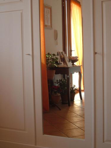 a room with a table and a mirror at B&B Il Guado in Voghenza