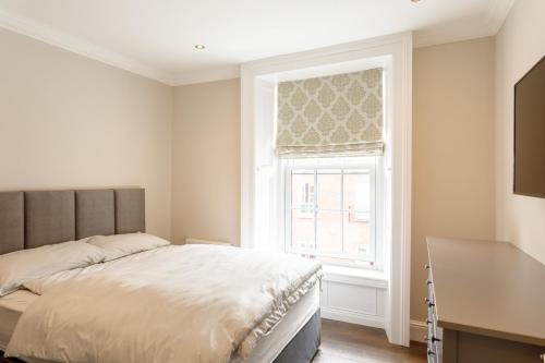 a bedroom with a bed and a window at Molloy's Apartments in Dublin
