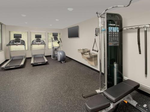 a gym with several machines in a room at WoodSpring Suites Seattle Tukwila in Tukwila