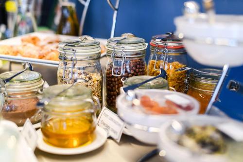 a table with jars of food and a plate of food at Best Western Hotel Jurata in Jurata
