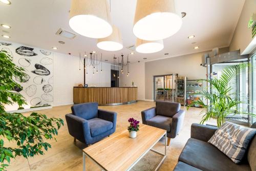 a waiting room with two chairs and a table at Best Western Hotel Jurata in Jurata