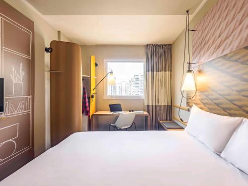 a hotel room with a bed and a desk at ibis Sao Paulo Ibirapuera in Sao Paulo