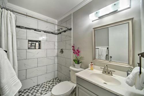 a bathroom with a sink and a toilet and a mirror at Cozy San Antonio Family Home 3 Mi to Lackland AFB in San Antonio