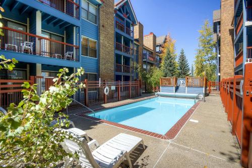 a swimming pool in the courtyard of a apartment building at River Mountain Lodge in Breckenridge