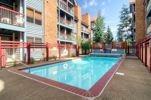 a swimming pool at a apartment complex with a building at River Mountain Lodge in Breckenridge