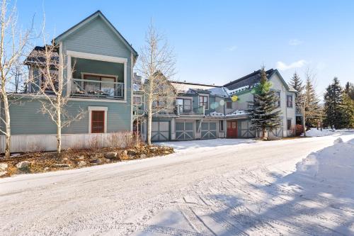 a house on a snow covered street with a driveway at Main Street Junction in Breckenridge