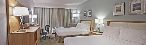 a hotel room with a bed and a desk at Holiday Inn Manahawkin/Long Beach Island by IHG in Manahawkin
