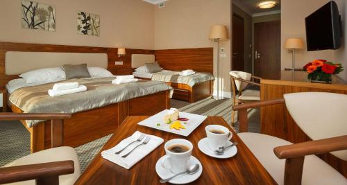 a hotel room with two beds and a table at Best Western Hotel Jurata in Jurata