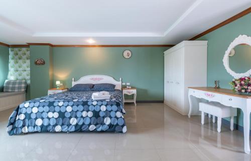 a bedroom with a bed and a desk at The Lilly Hotel in Chiang Mai
