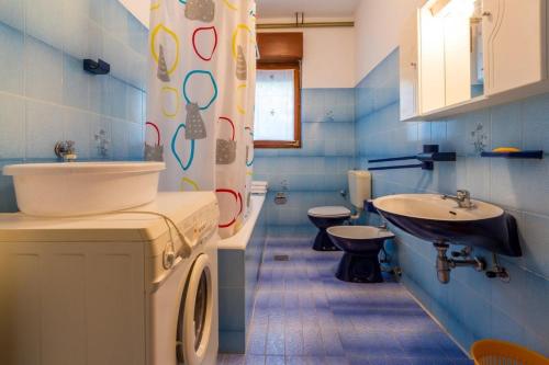 a blue bathroom with a sink and a toilet at Apartment in Dramalj 5751 in Dramalj
